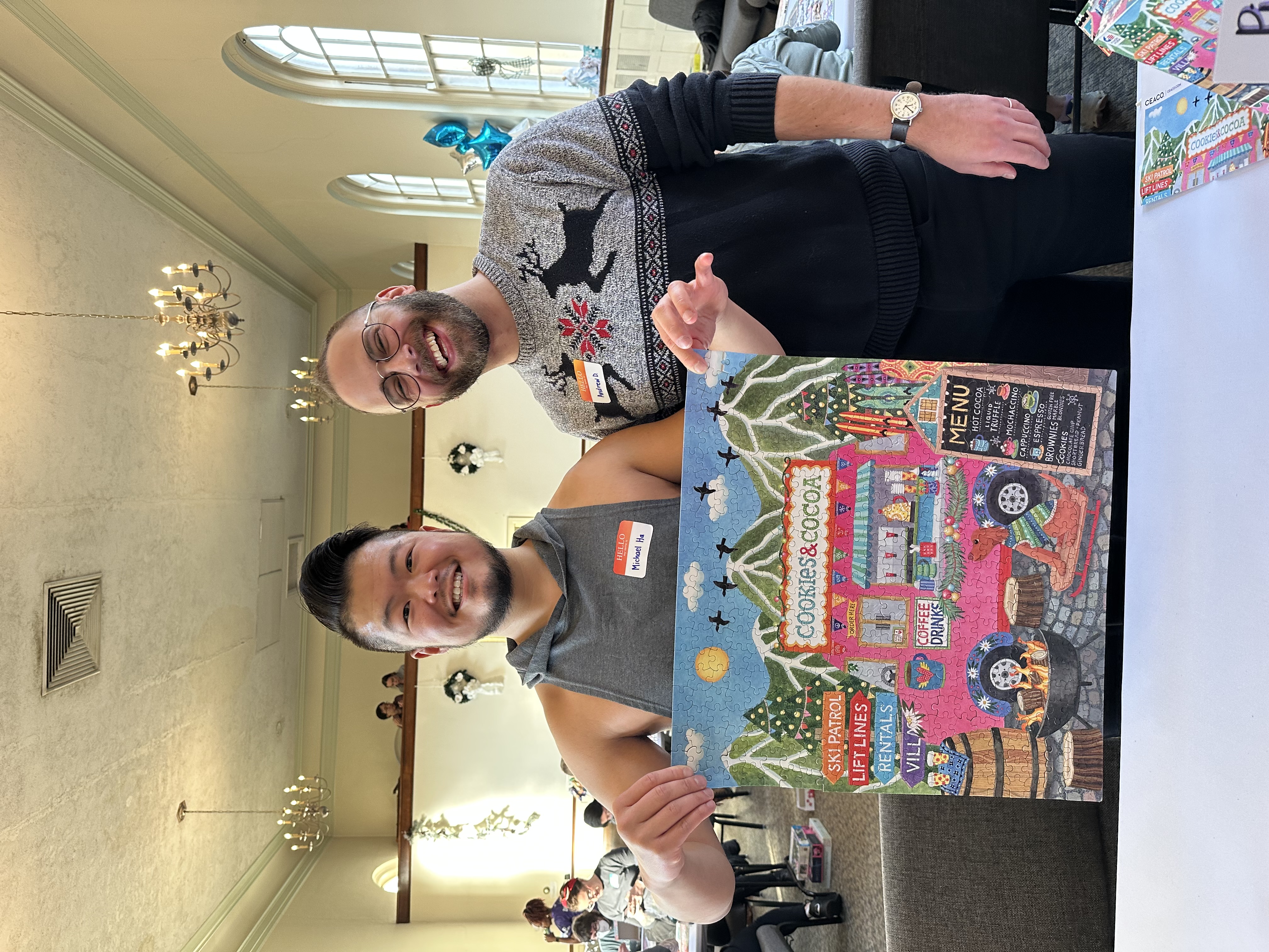 A photo of Michael and Andrew holding up our completed puzzle, Festive Food Truck.